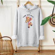 Our gender-neutral hoodie features a cute cartoon gingerbread woman who's ready to take on the world with her trusty belt bag and Stanley tumbler. 