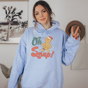 This hoodie features a cute cartoon gingerbread man with a broken leg and the hilarious phrase, "Oh Snap!" printed on the front.