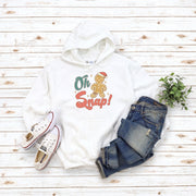 This hoodie features a cute cartoon gingerbread man with a broken leg and the hilarious phrase, "Oh Snap!" printed on the front.