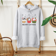  This cozy and comfortable gender-neutral hoodie is the ultimate gift for cat lovers and cupcake enthusiasts alike. Featuring adorable cartoon cats sitting in Christmas cupcakes, this hoodie is sure to bring a smile to anyone's face. 