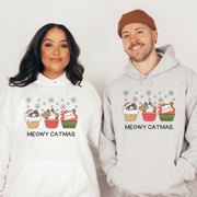  This cozy and comfortable gender-neutral hoodie is the ultimate gift for cat lovers and cupcake enthusiasts alike. Featuring adorable cartoon cats sitting in Christmas cupcakes, this hoodie is sure to bring a smile to anyone's face. 