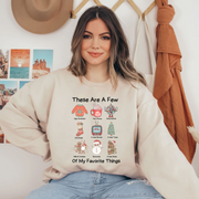 Our "These Are Some Of My Favorite Things" sweatshirt is the ultimate choice for anyone who loves to keep it cozy and festive during the holiday season.