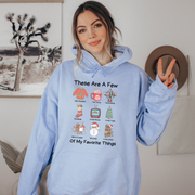 Our "These Are Some Of My Favorite Things" hoodie is the ultimate choice for anyone who loves to keep it cozy and festive during the holiday season. 