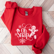 Our gender neutral sweatshirt features a charming gingerbread man with a broken leg, accompanied by the hilarious phrase "Oh Snap!". 