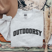 Introducing the ultimate sweatshirt for all the nature lovers out there! Our gender-neutral sweatshirt with the saying "Outdoorsy" is the perfect addition to your adventure attire. Whether you're hiking up a mountain or roasting marshmallows around the campfire, this sweatshirt will keep you warm and stylish.