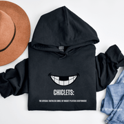 Our gender-neutral Chiclets hoodie is the ultimate statement piece for any hockey lover. Featuring a smiling mouth with missing front teeth, this hoodie perfectly captures the rugged and tough spirit of hockey players.