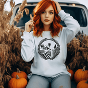 This gender-neutral sweatshirt features a unique graphic of a farmers field, showcasing the beauty of the prairie landscape and the importance of agriculture in Manitoba. 