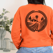 The Prairie Harvest sweatshirt features a stunning graphic of a Manitoba farmers field, paying homage to the beautiful prairie landscape.