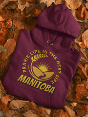 Harvest Hoodie with a beautiful graphic of a farmer's field, wheat, and a prairie sunset with the phrase Prairie Life Is The Best Life perfectly captures the essence of living in Manitoba.