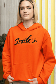 Introducing the perfect hoodie to brighten up even the gloomiest of days - the gender-neutral "Smile" hoodie! With a bold and playful "Smile" written across the front, and a cheeky smiley face sticking its tongue out, this hoodie is sure to put a grin on anyone's face. 