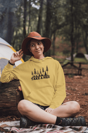 Introducing our gender-neutral hoodie featuring a stunning forest scene and the motivational slogan "Take A Hike". This cozy and stylish hoodie is perfect for any adventure seeker, whether hitting the trails for a day hike or embarking on a longer journey. 